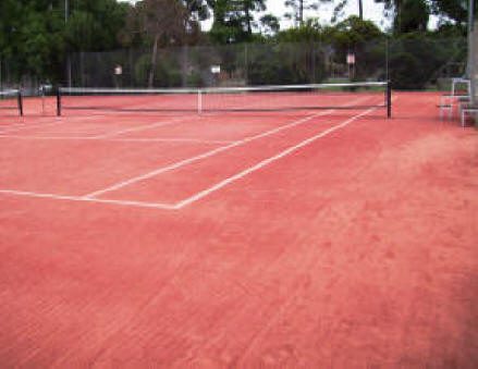 Red sand infill in red synthetic grass